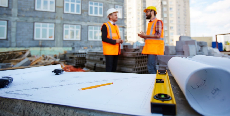 Construction team reviewing building plans on site in Los Angeles by Best General Contractor LA